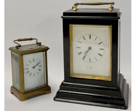 A French ebonised carriage type mantel timepiece, late 19th century, four-glass case with brass swing carrying handle, Roman 