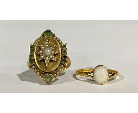 A 22ct gold ring, set with a polished opal cabochon, size N, 1.2g; a ring, unmarked gold shank, metal bezel, a marriage of tw