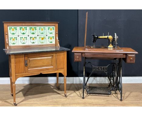 An Art Nouveau period tile-back marble top washstand, 115.5cm high, 91.5cm wide, 46cm deep; a Jones treadle sewing machine (2