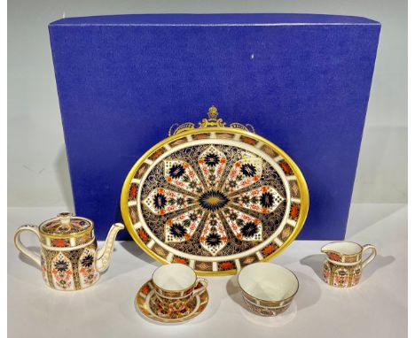 A Royal Crown Derby Imari palette 1128 pattern miniature tea set on oval tray, first quality, boxed 