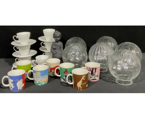 A set of seven Moomin mugs, by Arabia Finland; a set of seven Rosenthal teacups and saucers; a Ghanaian Clonette Auntie Deide