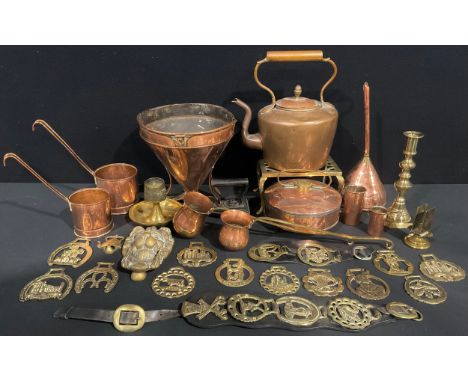A Victorian copper kettle; a brass trivet; a copper grain funnel; a copper wine funnel; assorted coppe and brass ladle measur
