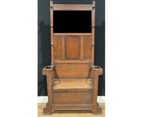 A 17th century style oak entrance hall box settle, rectangular back with bevelled mirror plate flanked by hanging hooks, hing
