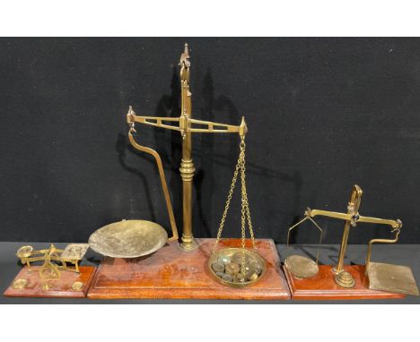 A set of brass banker's beam scales, P. Rogers &amp; Co., mahogany rectangular base, with a selection of brass weights, 53cm 