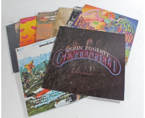 8 x Rock LPs. John Fogerty - Centerfield (925 203-1). Jerry Garcia - Garcia (RX 59301). The Guess Who - American Woman (LSP 4