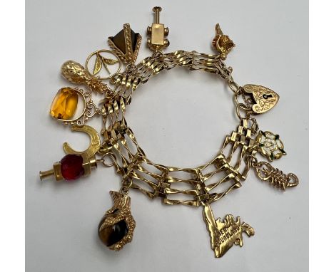 A 9 carat gold charm bracelet and various charms. All hallmarked 9 carat gold apart from horse shoe and circular charm which 