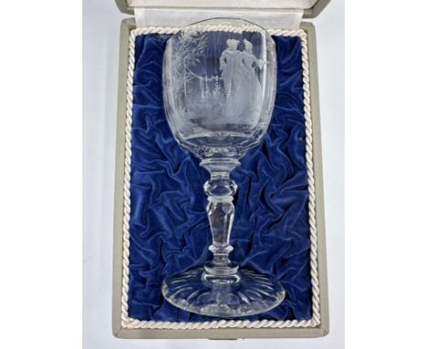 A Moser wine glass with engraved decoration of a courting couple and trees. Moser mark to base. In fitted box. 17.5cm h.