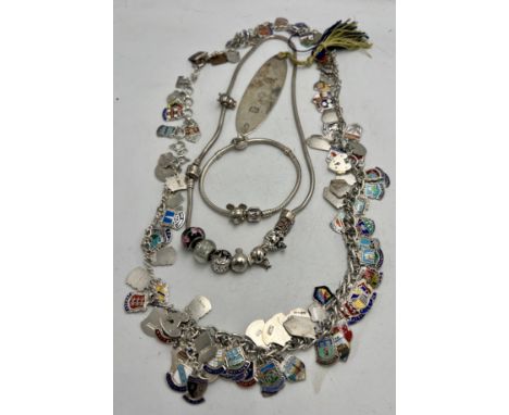 A silver necklace with mainly silver and enamel charms together with a pandora necklace and bracelet with .925 silver charms 