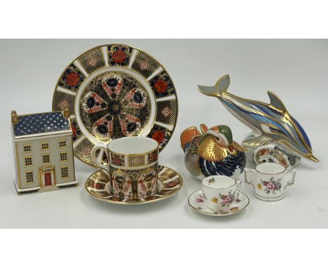 A selection of Royal Crown Derby to include Dolphin Paperweight with gold stopper, Mandarin Duck paperweight with silver stop