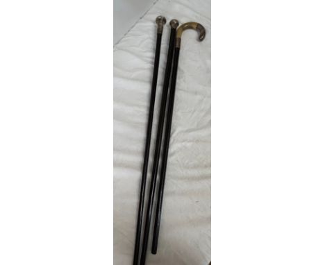Two hallmarked silver topped ebonised walking canes and a horn handled walking stick with hallmarked silver tip and collar in