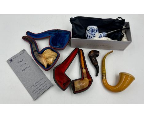Five pipes to include two meerschaum both with amber stems, one with white metal mounts in fitted case, a Baronite 12201, a s