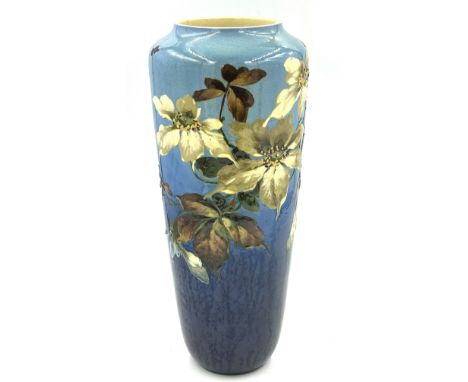 A late 19thC Leeds Art vase with floral decoration on a blue ground. 42cm h.