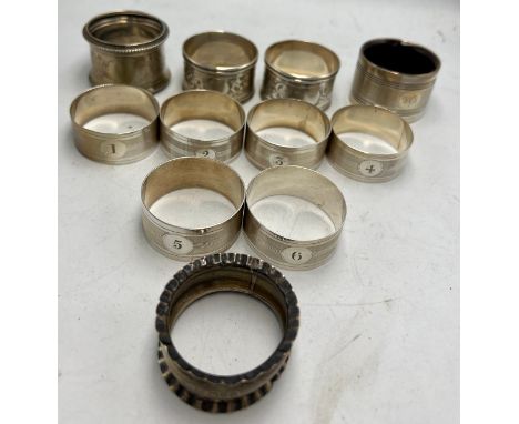 Eleven various hallmarked silver napkin rings to include a set of six numbered 1-6. Various dates and makers. Weight 177gm.