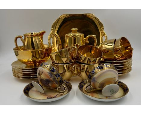 A Noritake part tea set in gold comprising of a cake plate, 6 x cups &amp; saucers, 6 x tea plates, sugar bowl &amp; milk jug
