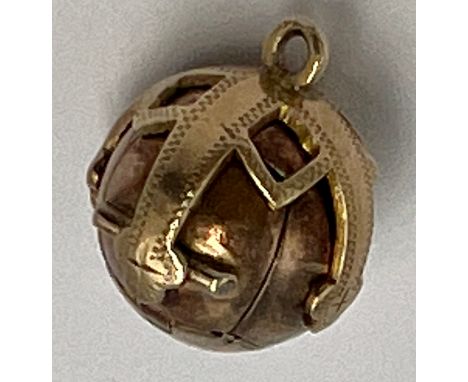 A 9 carat gold and silver Masonic ball pendant opening to reveal hieroglyphics. Weight 6.9gm.
