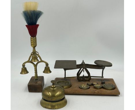 Brass items to include a set of postal scales with complete weights, a terret and a countertop bell. (3)