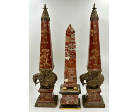 A pair of Wong Lee ceramic and brass obelisks, decorated with deer, trees and butterflies mounted on a brass elephant with br