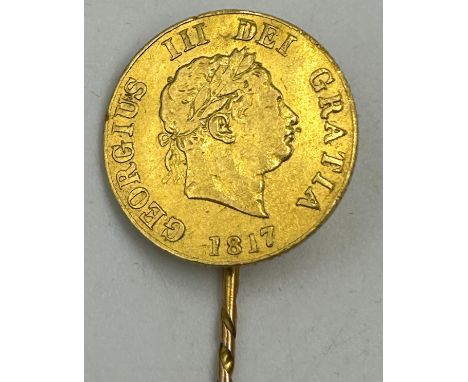 An 1817 George III gold half sovereign with shield back soldered to form a stick pin. Total weight 4gm.