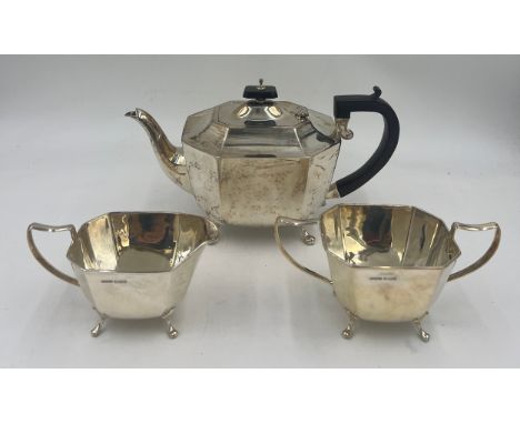 A three piece silver tea service Sheffield 1945, with ebony knop and handle, maker Harrison, Fisher &amp; Co. Total weight 11