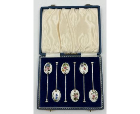 A set of Six Silver and Enamel Coffee Spoons decorated with flowers in a blue case. Makers mark Henry Clifford Davis Birmingh