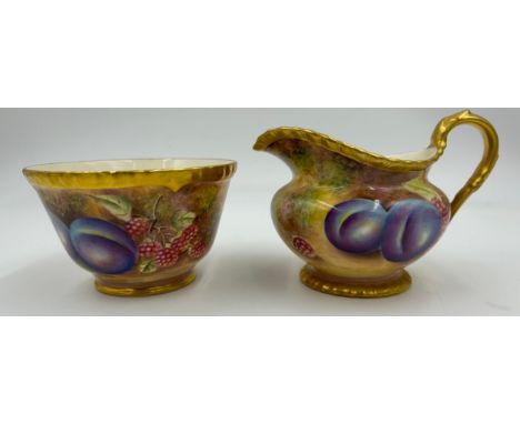 A Royal Worcester sugar bowl 11.5cm d and milk jug 9cm h decorated with plums and berries on a moss background and gilt edge 