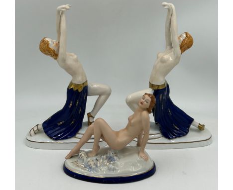 A pair of Austrian Wien porcelain semi nude figurines depicting dancers in an Art Deco style with gilt and cobalt  detailing,