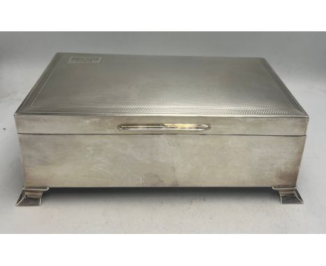 A silver engine turned cigarette box Birmingham 1956, maker Bert Gordon. 17cm x 10cm. Weight 519gm.