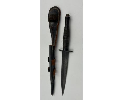 A Fairbairn Sykes 3rd pattern Commando Dagger by William Rogers, Sheffield with leather cover, makers mark stamped to crossba
