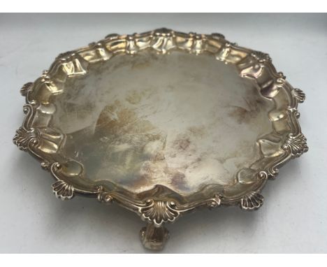 A silver salver London 1900, maker Johnson, Walker &amp; Tolhurst Ltd. Raised on three scroll feet.  Weight 455gm. 20cm diame