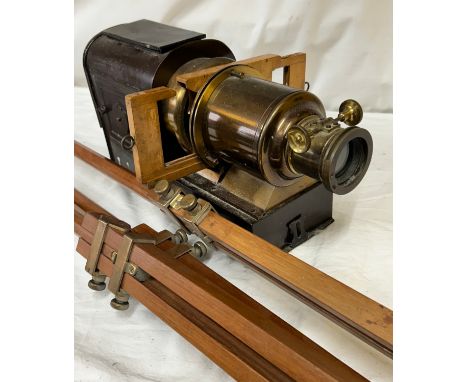 A magic lantern slide projector with electric conversion  together with a wood and brass adjustable tripod.