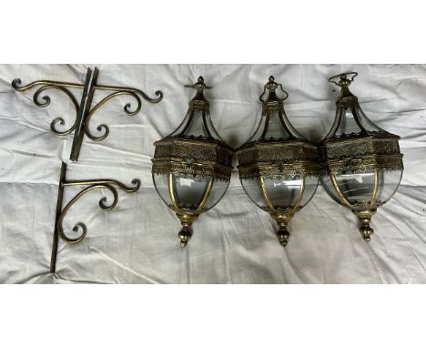 Three decorative brass hanging lanterns with brackets for wall mounting. Lantern 53cm h approx.