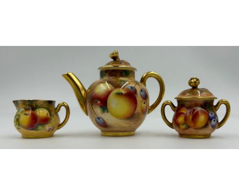 A Royal Worcester fruit decorated three-piece miniature tea set, teapot by Roberts 8cm, jug by P. Platt 3.5cm and lidded suga