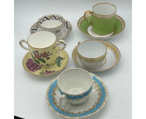 A group of early 19th century hand-painted porcelain cups and saucers with gilding, and hand-painted floral decoration, c. 18