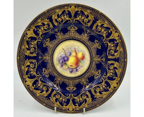A Royal Worcester porcelain plate hand decorated by R. Price with cobalt blue ground, gilt foliate and scroll decoration and 