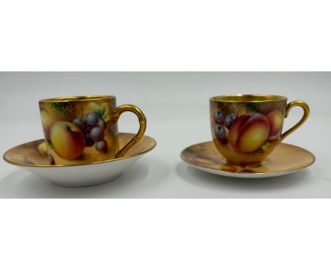 A Royal Worcester coffee can and saucer and a cabinet cup and saucer, both painted with fruit on a mossy background by Robert