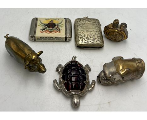 Five vesta cases and a lighter to include brass pig, bulldog, turtle and Molassine meal etc. (6)