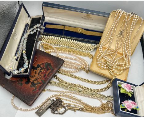 A quantity of costume jewellery to include ladies wristwatch, silver ingot, pearl necklaces etc.