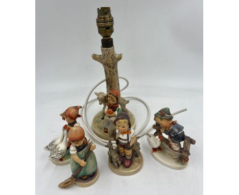 A Hummel pottery table lamp, 19cm high to fitting and four various Hummel figures.