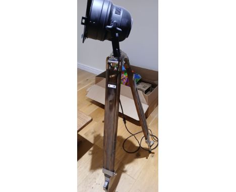 A black metal lamp on wooden tripod base. 134cm h.