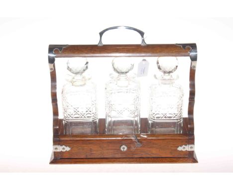 Oak tantalus with three decanters plus three plated decanter labels, 36cm by 33cm