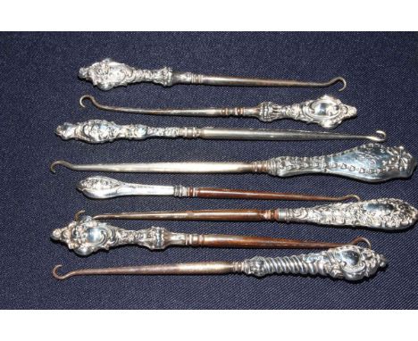 Eight silver button hooks