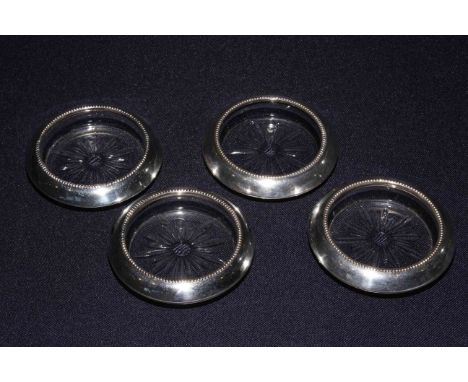 Set of four sterling silver glass coasters