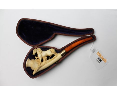 Horse form clay pipe with amber coloured plastic tip, with case