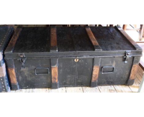 A vintage metal and oak bound travelling trunk