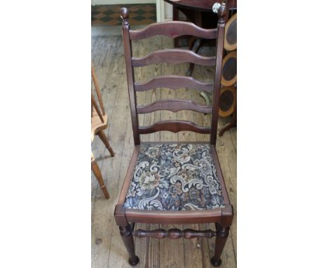 A set of four oak high ladder back dining chairs with tapestry upholstered seats