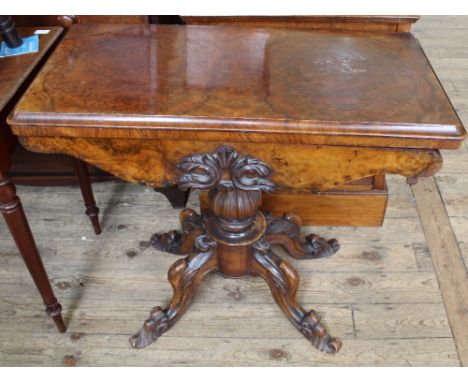 A 19th Century carved burr walnut games table on tripod base with quatrefoil supports