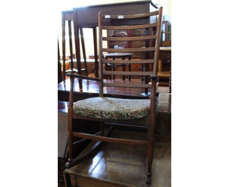 A modern oak upholstered ladder back rocking chair