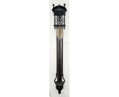 A 17TH C STYLE CARVED OAK BAROMETER, WITH ENGRAVED AND SILVERED REGISTER, FORMERLY WITH VERNIER, THE ARCHED PEDIMENT ON SPIRA
