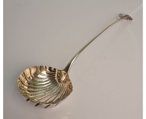 A silver George III ladle of shell design with scroll top handle, hallmarked London, date possible 1798 or 1818, approx. leng