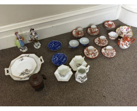 A Japanese style part tea set, together with two blue and white Chinese style cups and saucers, two German style figures, woo